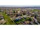 An aerial view of a suburban neighborhood with well-maintained homes, lush green spaces, and tree-lined streets at 4465 E 121St Pl, Thornton, CO 80241