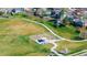 An aerial view of a neighborhood park featuring a playground, walking path, and open green space at 4465 E 121St Pl, Thornton, CO 80241