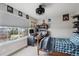 Sports-themed bedroom featuring a large window, desk and sports posters at 13561 W 87Th Dr, Arvada, CO 80005