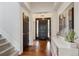 Inviting home entryway featuring hardwood floors, a stylish console table, and modern decor at 13561 W 87Th Dr, Arvada, CO 80005