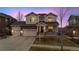 Charming two-story home featuring a three-car garage and a beautiful stone accent on the facade at 13561 W 87Th Dr, Arvada, CO 80005