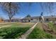 Spacious backyard with lush grass and a charming covered patio, great for entertaining at 1675 N Wabash St, Denver, CO 80220