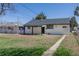 Exterior view of the home showcasing the spacious backyard and covered patio area at 1675 N Wabash St, Denver, CO 80220