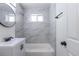 Bathroom with modern tiles, vanity with a sink, a round mirror, shower and bathtub at 1675 N Wabash St, Denver, CO 80220