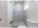 Bathroom features updated shower with marble-look tile and sleek hardware at 1675 N Wabash St, Denver, CO 80220