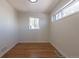 Bright bedroom featuring hardwood floors, neutral walls, and natural light from the windows at 1675 N Wabash St, Denver, CO 80220