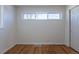Simple bedroom design with hardwood floors, white walls, and a window at 1675 N Wabash St, Denver, CO 80220