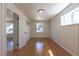 The bedroom features stylish wood-paneled walls, a large window, and beautiful wood floors at 1675 N Wabash St, Denver, CO 80220