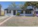 Charming single-story home with updated gray roof, white painted brick, and walkway path at 1675 N Wabash St, Denver, CO 80220