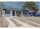 The home has fresh exterior paint, a new roof, and mature landscaping in the front yard at 1675 N Wabash St, Denver, CO 80220