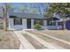 The exterior features a freshly painted white house, a new roof, and mature trees in the front yard at 1675 N Wabash St, Denver, CO 80220