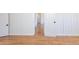 Hallway with wood paneled walls and wood floors leads to bedrooms and bathrooms at 1675 N Wabash St, Denver, CO 80220