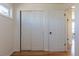Hallway with hardwood floors featuring closets and doors to the rooms at 1675 N Wabash St, Denver, CO 80220