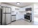 Bright kitchen features white cabinets, white subway tile backsplash, and stainless steel appliances at 1675 N Wabash St, Denver, CO 80220