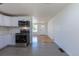 Modern kitchen featuring stainless steel appliances, white cabinetry, and hardwood floors at 1675 N Wabash St, Denver, CO 80220