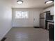 Eat-in kitchen area featuring updated modern appliances, white cabinets and tile flooring at 1675 N Wabash St, Denver, CO 80220
