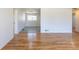 Open-concept living room with refinished hardwood floors and seamless flow into the dining area at 1675 N Wabash St, Denver, CO 80220