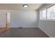 The living room features gray wood-look floors and a large window that provides plenty of natural light at 1675 N Wabash St, Denver, CO 80220