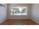 Bright living room with hardwood floors and large windows showcasing the outdoor view at 1675 N Wabash St, Denver, CO 80220