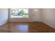Sun-filled living room showcasing newly refinished hardwood floors and a large picture window at 1675 N Wabash St, Denver, CO 80220
