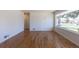 Open-concept living room featuring refinished hardwood floors and an abundance of natural light at 1675 N Wabash St, Denver, CO 80220