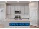 Modern kitchen features stainless steel appliances, gray cabinets, white countertops, and subway tile backsplash at 8945 Rifle St, Commerce City, CO 80022