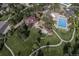 Aerial view highlighting the clubhouse, pool, and surrounding green spaces at 24714 E Quarto Pl, Aurora, CO 80016