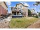 Multi-level backyard with deck, lawn, stone accents, and a fence around the property at 24714 E Quarto Pl, Aurora, CO 80016