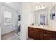 Clean bathroom featuring a shower, toilet, vanity, and a mirror at 24714 E Quarto Pl, Aurora, CO 80016