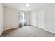 Bright bedroom with neutral walls, carpet, window with curtains, and closet at 24714 E Quarto Pl, Aurora, CO 80016