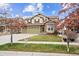 Beautiful two-story home with a three car garage, stone accents, and a well-manicured lawn at 24714 E Quarto Pl, Aurora, CO 80016