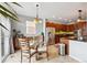 Bright breakfast nook connected to the kitchen with a glass table and views to the back patio at 24714 E Quarto Pl, Aurora, CO 80016