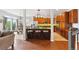 Open-concept kitchen featuring an island with seating and views into the adjacent dining and living areas at 24714 E Quarto Pl, Aurora, CO 80016
