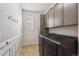 Efficient laundry room featuring modern appliances, storage cabinets, and convenient hanging hooks at 24714 E Quarto Pl, Aurora, CO 80016