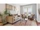 Cozy living room featuring neutral tones, a decorative rug, and plenty of seating for relaxation at 24714 E Quarto Pl, Aurora, CO 80016