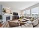 Inviting living room features a tiled fireplace, large TV, and sectional sofa by the window at 24714 E Quarto Pl, Aurora, CO 80016