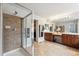 Luxurious primary bathroom with double vanity, large mirror, and walk-in shower at 24714 E Quarto Pl, Aurora, CO 80016