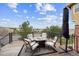Outdoor patio features table with 4 chairs, a view, and a black metal fence at 24714 E Quarto Pl, Aurora, CO 80016