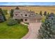 Aerial view of a spacious home with a large yard and mature trees on a sprawling property at 5861 E Valley Hi Dr, Parker, CO 80138