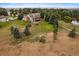 Aerial view of the home on a grassy lot featuring mature trees, recreational equipment, and covered deck at 5861 E Valley Hi Dr, Parker, CO 80138