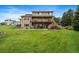 Expansive backyard featuring a two-story deck and large green lawn ideal for outdoor enjoyment at 5861 E Valley Hi Dr, Parker, CO 80138