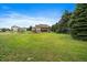 Vast backyard with play structure and trampoline surrounded by a beautiful lush green yard at 5861 E Valley Hi Dr, Parker, CO 80138