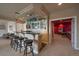 Basement bar features dark countertops, bar seating, and decorative lighting at 5861 E Valley Hi Dr, Parker, CO 80138