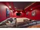 Home theater in basement features a large sectional sofa, theater decor and entertainment center at 5861 E Valley Hi Dr, Parker, CO 80138