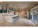 Basement bar area features bar stool seating, airplane decor, and a slider to the backyard at 5861 E Valley Hi Dr, Parker, CO 80138