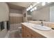Bathroom with double sink vanity, tile floor and shower-tub combo at 5861 E Valley Hi Dr, Parker, CO 80138