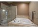 Bathroom boasting glass shower, soaking tub with jets, and neutral tiling at 5861 E Valley Hi Dr, Parker, CO 80138