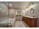 Elegant bathroom featuring a glass shower, soaking tub, double vanity, and stained-glass window at 5861 E Valley Hi Dr, Parker, CO 80138