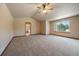 Large bedroom featuring a ceiling fan, en suite bathroom, and great natural light at 5861 E Valley Hi Dr, Parker, CO 80138