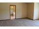 Spacious bedroom featuring neutral carpeting and an en-suite bathroom for added privacy and convenience at 5861 E Valley Hi Dr, Parker, CO 80138